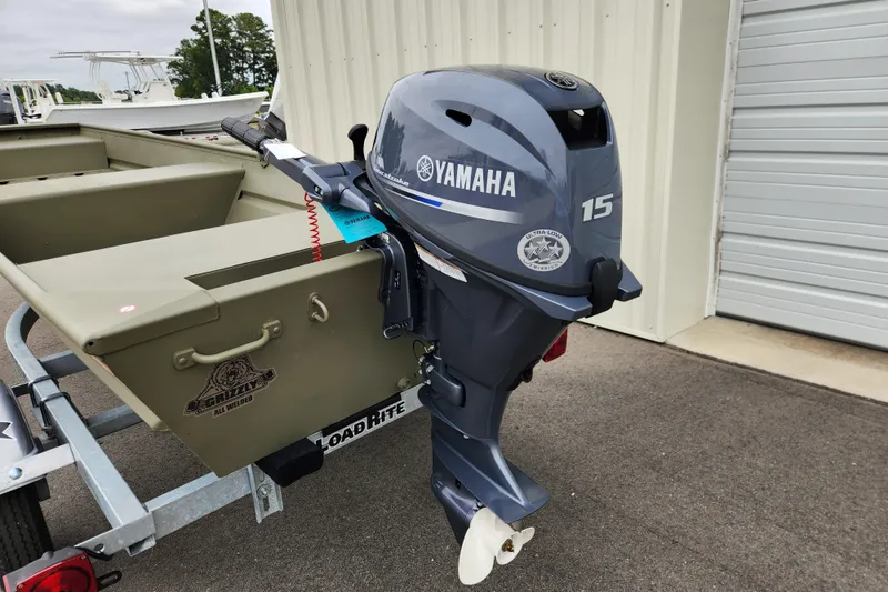 Slide: The Image of 2026 Tracker Grizzly 1436 Utility boat with Yamaha 15 outboard motor, parked on trailer. - 8