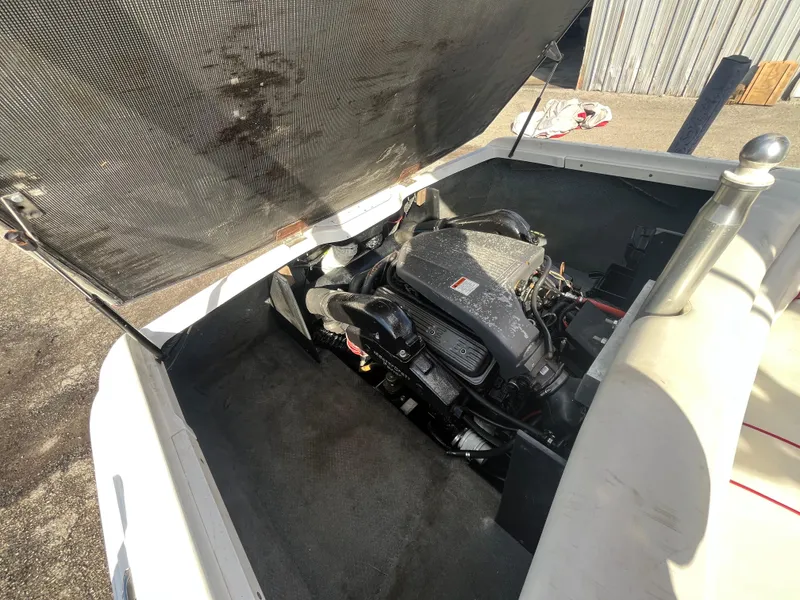 Slide: The Image of 1999 MasterCraft XStar engine compartment with open cover, showcasing the boat's engine. - 7