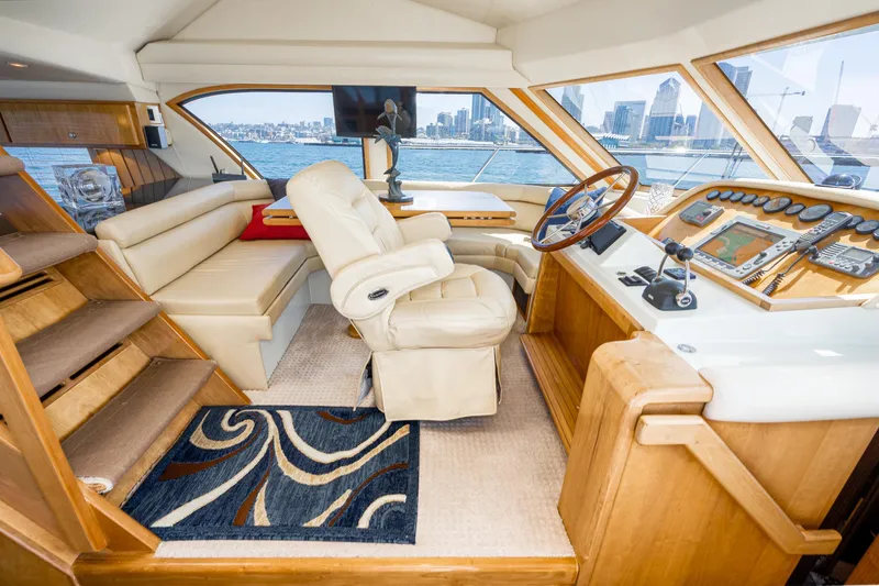 Slide: The Image of Luxurious 2006 Navigator 5100 yacht interior with helm, leather seating, and city skyline view. - 13