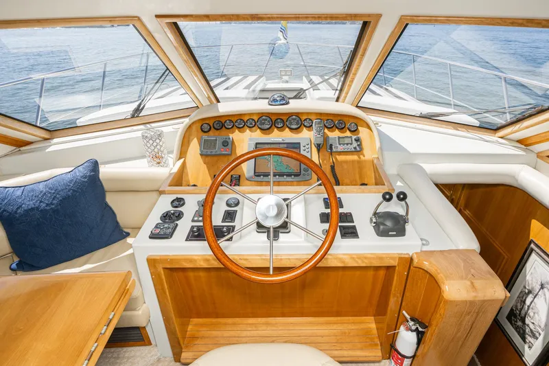 Slide: The Image of Helm of 2006 Navigator 5100 yacht with wooden steering wheel and navigation instruments. - 14