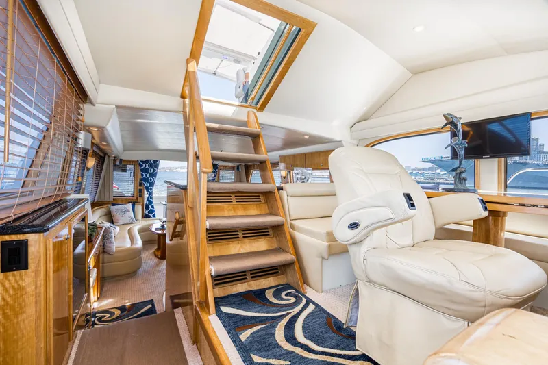 Slide: The Image of Luxurious interior of 2006 Navigator 5100 yacht with plush seating and elegant wood finishes. - 15