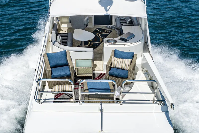 Slide: The Image of Luxurious 2006 Navigator 5100 yacht cruising with elegant outdoor seating on deck. - 18