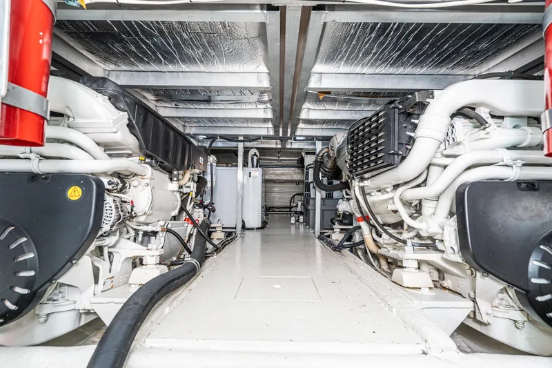 Slide: The Image of Engine room of 2006 Navigator 5100 yacht, showcasing dual engines and mechanical systems. - 25
