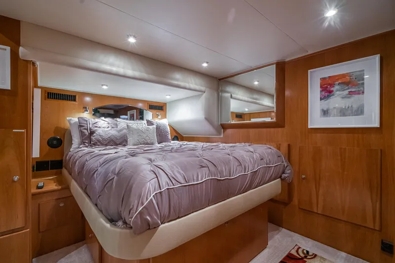 Slide: The Image of Luxurious bedroom interior in a 2006 Navigator 5100 yacht, featuring elegant bedding and modern decor. - 31