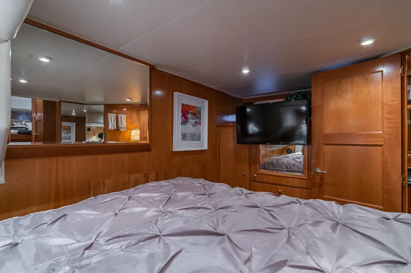 Slide: The Image of Luxurious bedroom interior of 2006 Navigator 5100 yacht with wood paneling and TV. - 32
