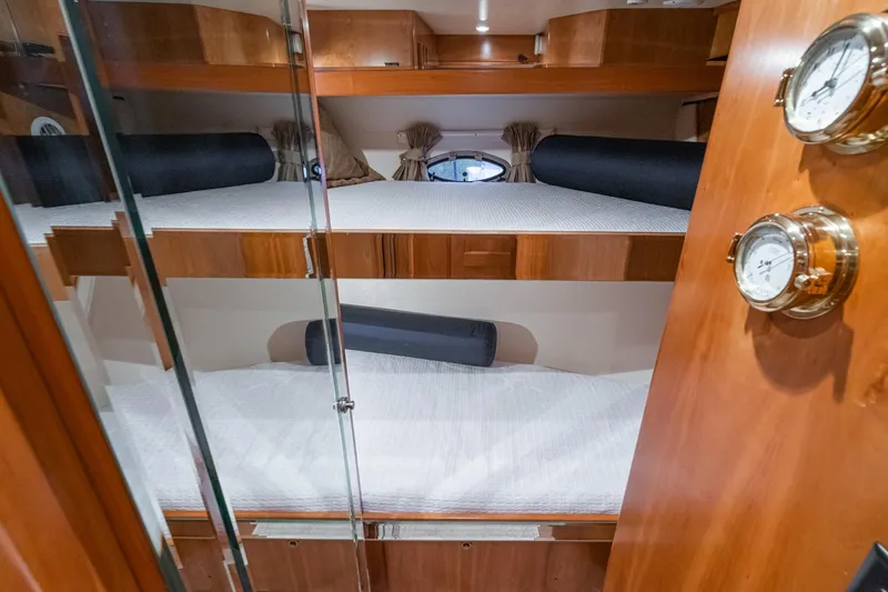 Slide: The Image of Bunk beds in 2006 Navigator 5100 yacht cabin with wooden interior and nautical decor. - 39