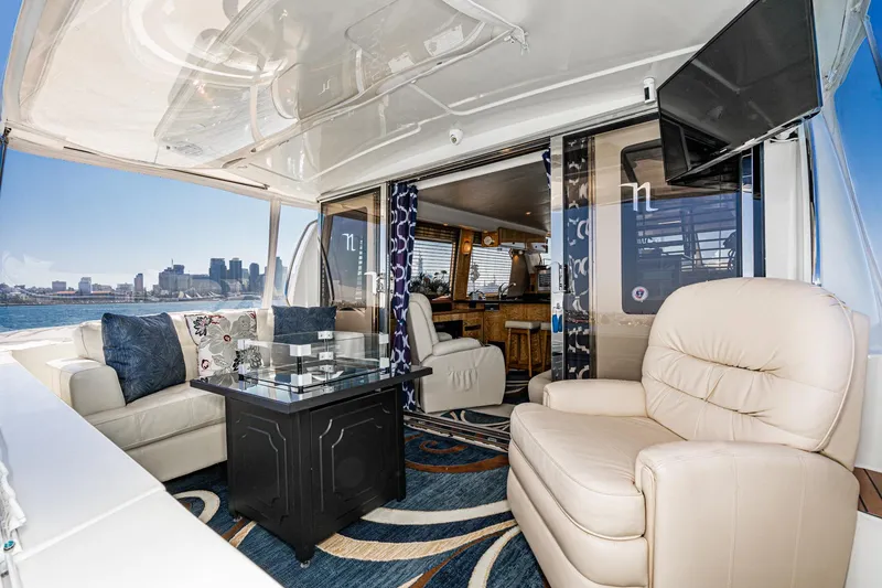 Slide: The Image of Luxurious 2006 Navigator 5100 yacht interior with plush seating and city skyline view. - 4