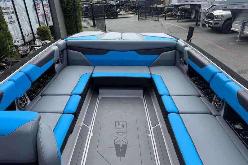 Slide: The Image of 2023 Axis A24 boat interior with blue and gray seating, showcasing spacious design. - 19