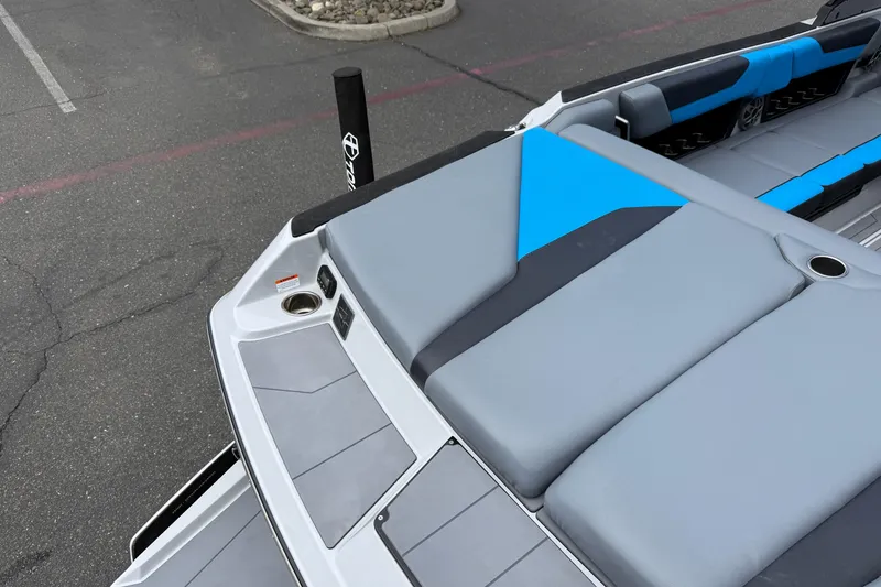 Slide: The Image of 2023 Axis A24 boat interior with gray and blue seating, cup holders, and sleek design. - 27