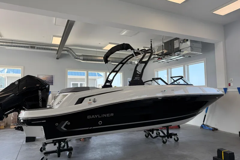 Slide: The Image of 2026 Bayliner VR6 Bowrider OB in showroom, featuring sleek design and modern outboard motor. - 1