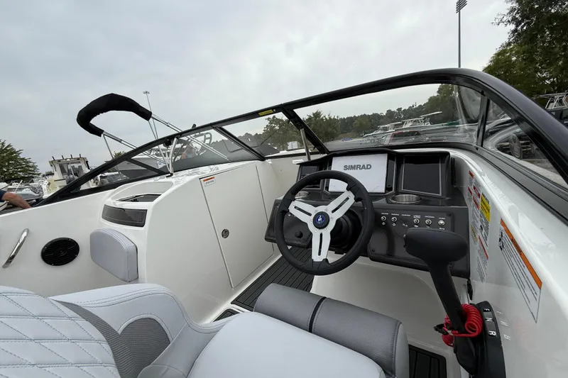 Slide: The Image of 2026 Bayliner VR6 Bowrider OB interior with steering wheel and control panel. - 2