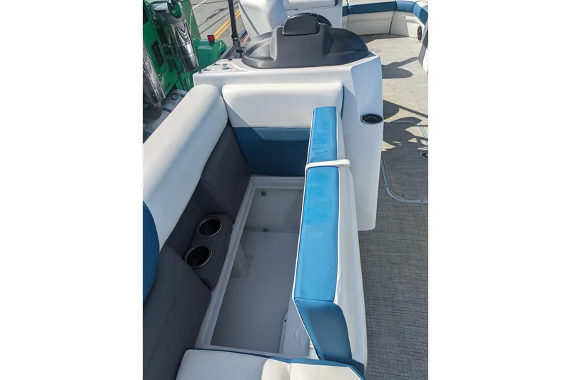 Slide: The Image of 2023 Berkshire 24RFX CTS boat interior with blue and white seating and storage compartment. - 18