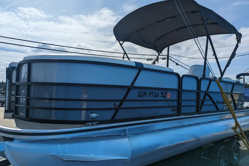 Slide: The Image of 2023 Berkshire 24RFX CTS pontoon boat with canopy, docked under a clear sky. - 3