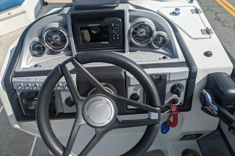 Slide: The Image of 2023 Berkshire 24RFX CTS boat dashboard with steering wheel and control panel. - 6