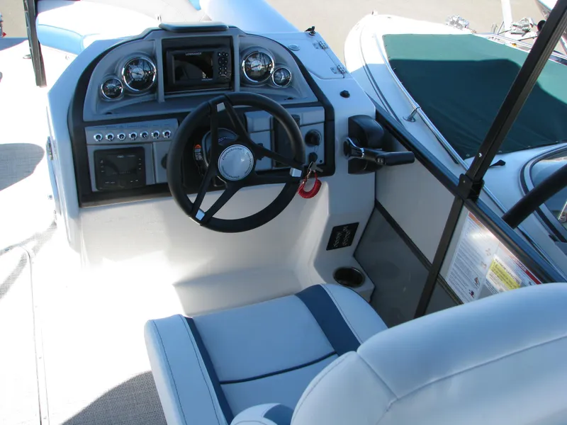 Slide: The Image of 2023 Berkshire 24RFX CTS boat cockpit with steering wheel and control panel. - 7