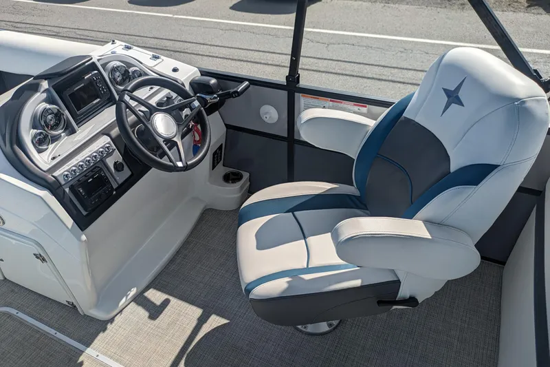 Slide: The Image of 2023 Berkshire 24RFX CTS boat interior with steering wheel and captain's chair. - 8