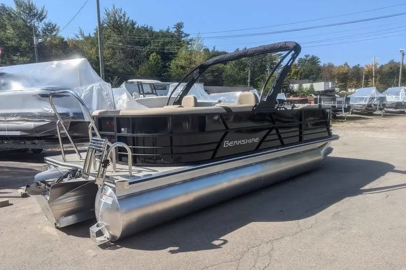 Slide: The Image of 2025 Berkshire 22RFX CTS pontoon boat in a parking lot, sunny day. - 2