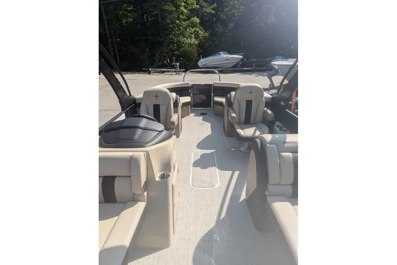 Slide: The Image of 2025 Berkshire 22RFX CTS pontoon boat interior with beige seating and open layout. - 5