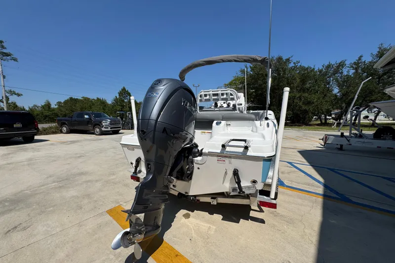 Slide: The Image of 2026 NauticStar 212 Legacy boat with outboard motor in parking lot. - 11