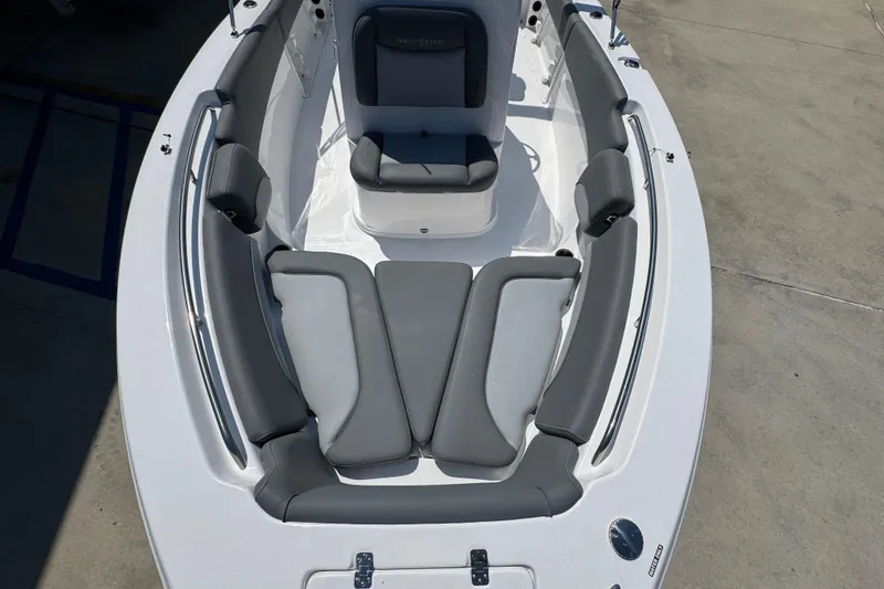 Slide: The Image of 2026 NauticStar 212 Legacy boat interior with gray cushioned seating. - 19