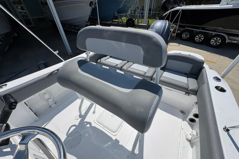 Slide: The Image of 2026 NauticStar 212 Legacy boat interior with gray seating and steering wheel. - 25