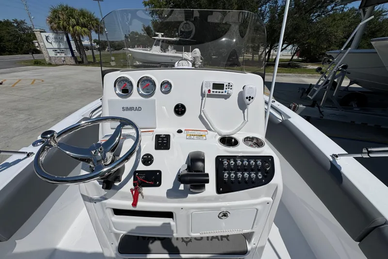 Slide: The Image of 2026 NauticStar 212 Legacy boat dashboard with steering wheel and control panel. - 29