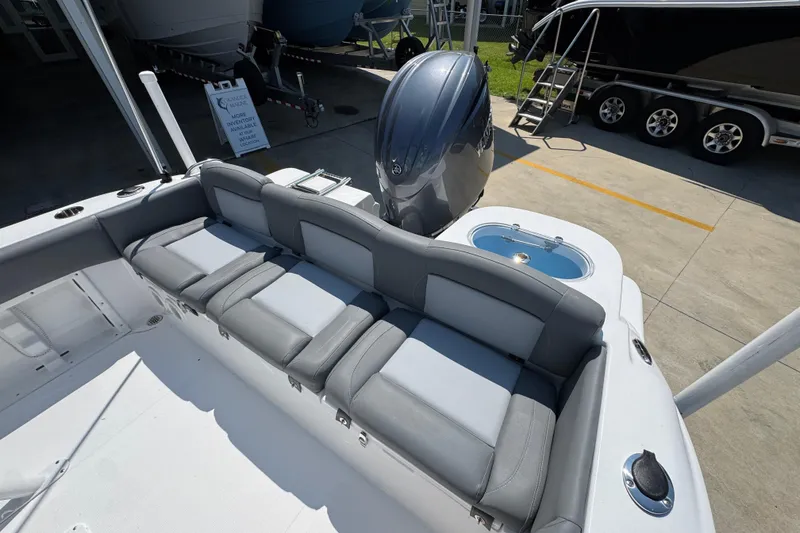 Slide: The Image of 2026 NauticStar 212 Legacy boat interior with cushioned seating and outboard motor. - 31