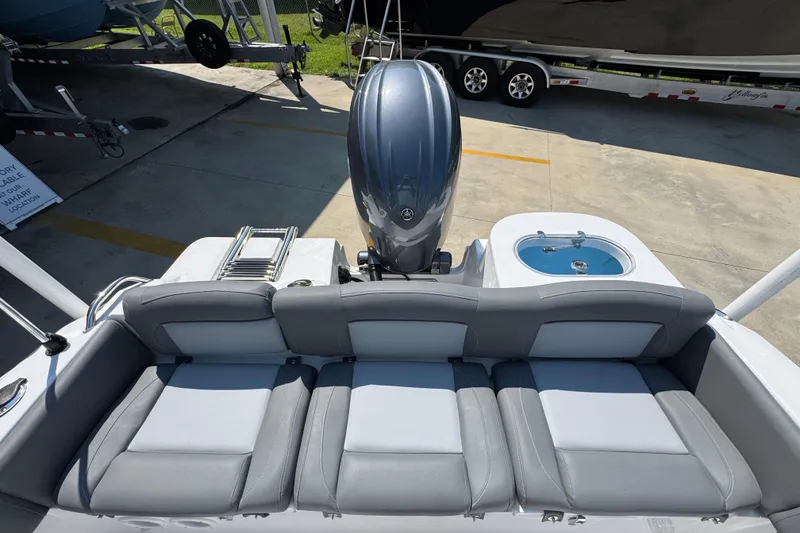 Slide: The Image of 2026 NauticStar 212 Legacy boat with outboard motor and seating area. - 32