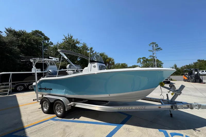 Slide: The Image of 2026 NauticStar 212 Legacy boat on trailer in sunny outdoor setting. - 7