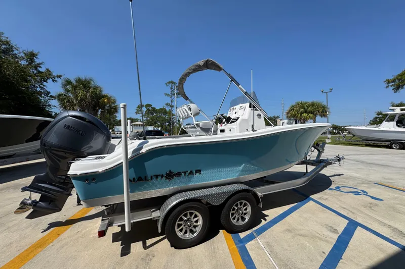 Slide: The Image of 2026 NauticStar 212 Legacy boat on trailer, featuring Yamaha outboard motor. - 9