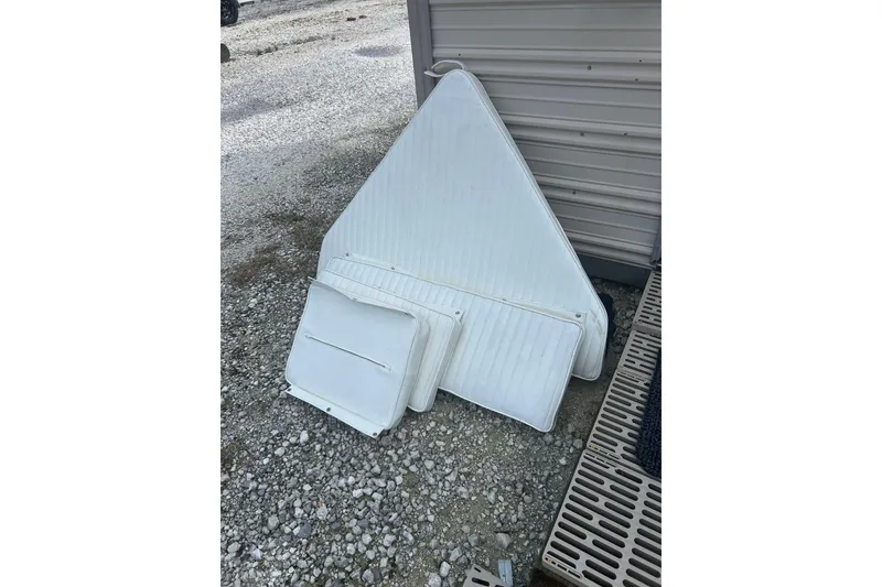 Slide: The Image of White boat cushions for 1991 Boston Whaler 15 GLS on gravel surface. - 6