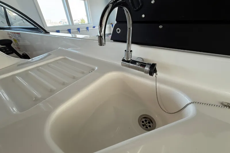 Slide: The Image of 2026 Bayliner D22 boat interior with sink and faucet detail. - 12