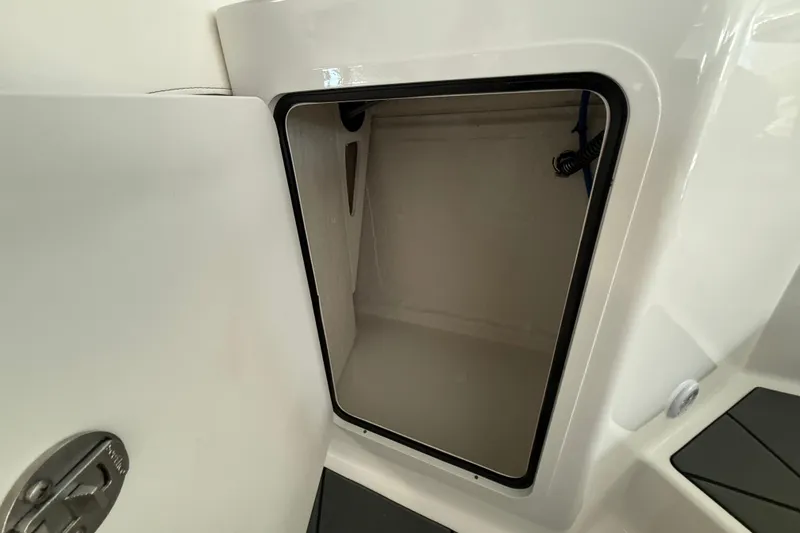 Slide: The Image of Open storage compartment on 2026 Bayliner D22 boat, showcasing interior space. - 13