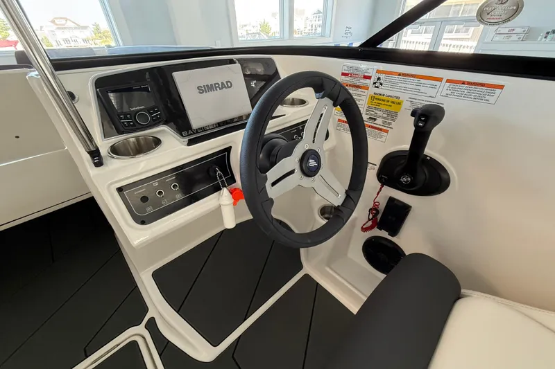 Slide: The Image of 2026 Bayliner D22 boat dashboard with steering wheel and control panel. - 5