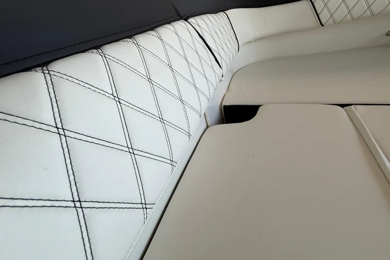Slide: The Image of Luxurious white seating with diamond stitching in 2026 Bayliner D22 boat interior. - 7