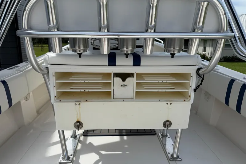 Slide: The Image of 2008 Contender 31 Cuddy boat interior with rod holders and storage compartments. - 13