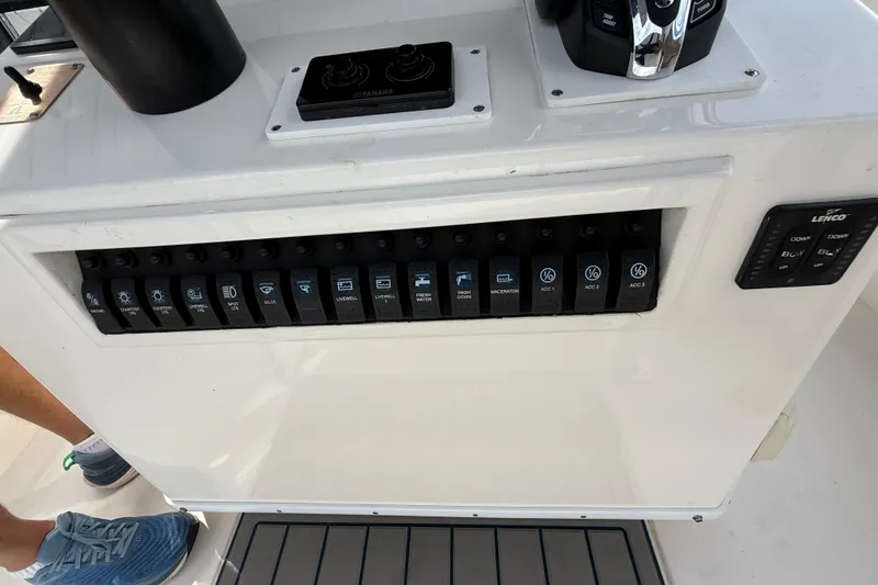 Slide: The Image of Control panel of a 2008 Contender 31 Cuddy boat with various switches and controls. - 24