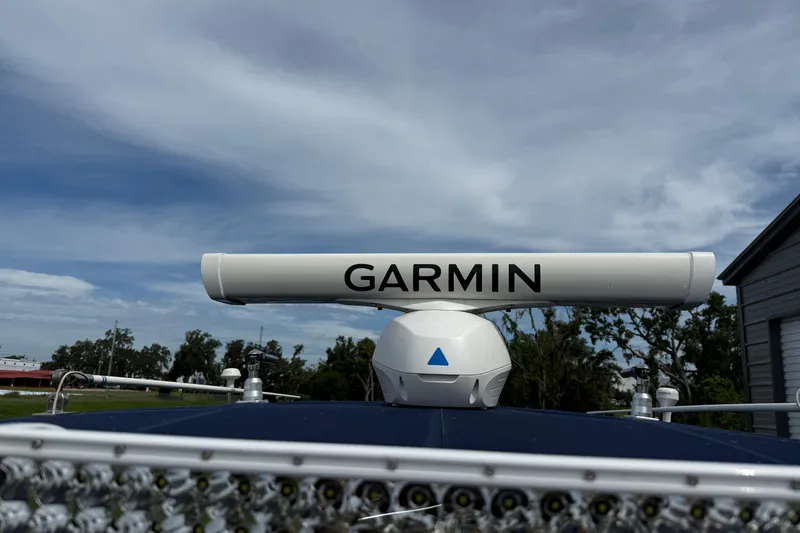 Slide: The Image of Garmin radar on 2008 Contender 31 Cuddy boat under a cloudy sky. - 25