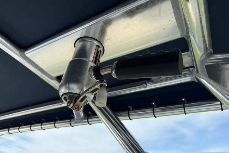 Slide: The Image of Close-up of a 2008 Contender 31 Cuddy boat's metal handle and structure. - 27