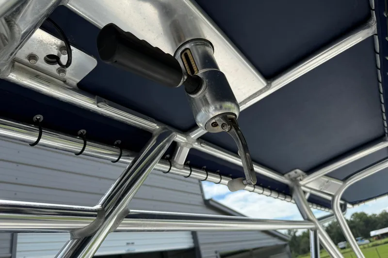 Slide: The Image of 2008 Contender 31 Cuddy boat T-top with rod holders and mounted equipment. - 28