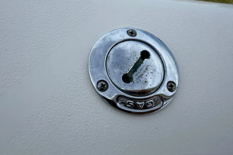 Slide: The Image of Gas cap on 2008 Contender 31 Cuddy boat, featuring a metallic finish. - 30