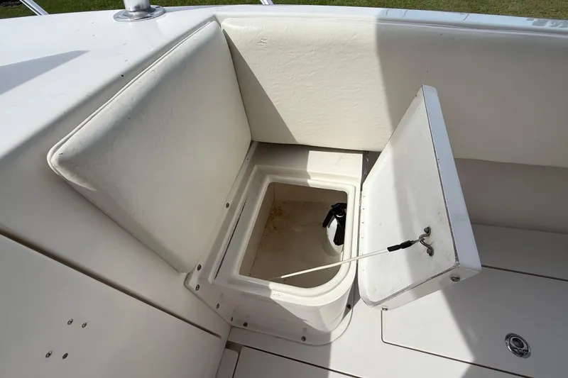 Slide: The Image of 2008 Contender 31 Cuddy boat with open storage compartment and cushioned seating. - 34