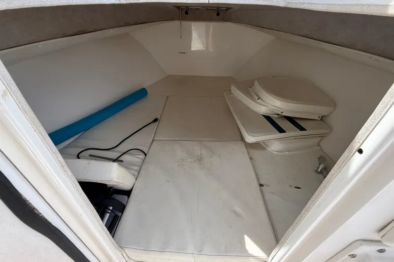 Slide: The Image of 2008 Contender 31 Cuddy cabin interior with cushions and storage space. - 35