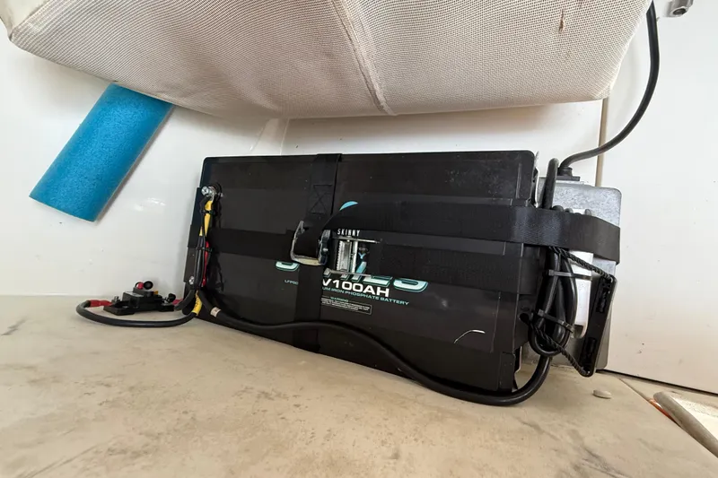 Slide: The Image of Battery setup in a 2008 Contender 31 Cuddy boat, featuring a lithium iron phosphate battery. - 36