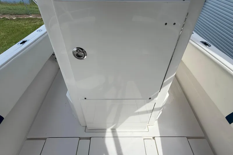Slide: The Image of 2008 Contender 31 Cuddy boat interior with white storage compartment. - 37