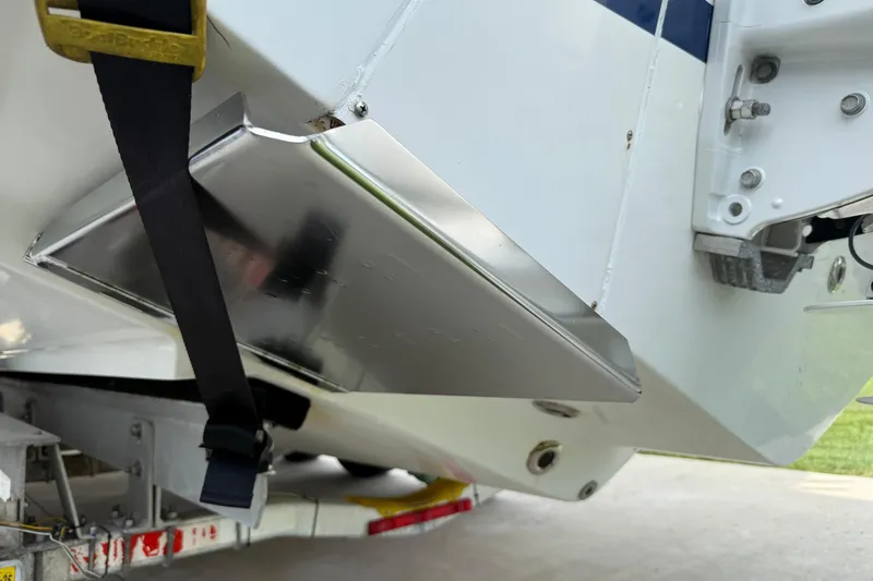 Slide: The Image of 2008 Contender 31 Cuddy boat on trailer, showing hull and metal components. - 39