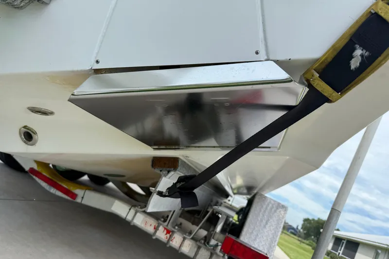 Slide: The Image of 2008 Contender 31 Cuddy boat on trailer, rear view with strap and metal components. - 40