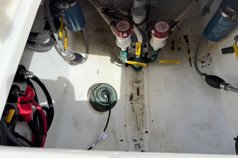Slide: The Image of 2008 Contender 31 Cuddy boat bilge area with valves and wiring. - 42