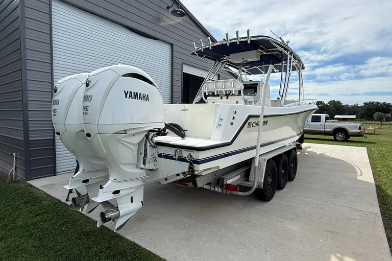 Slide: The Image of 2008 Contender 31 Cuddy boat with twin Yamaha V6 engines on a trailer. - 7