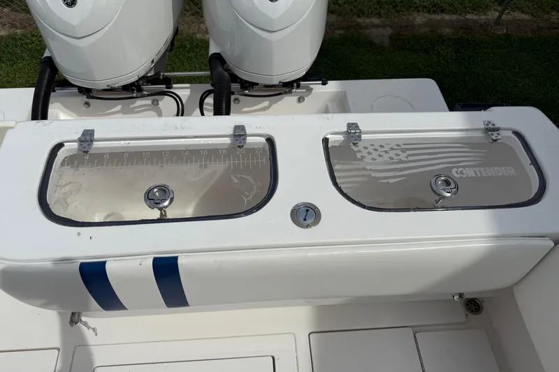 Slide: The Image of 2008 Contender 31 Cuddy boat with dual engines and storage compartments. - 9